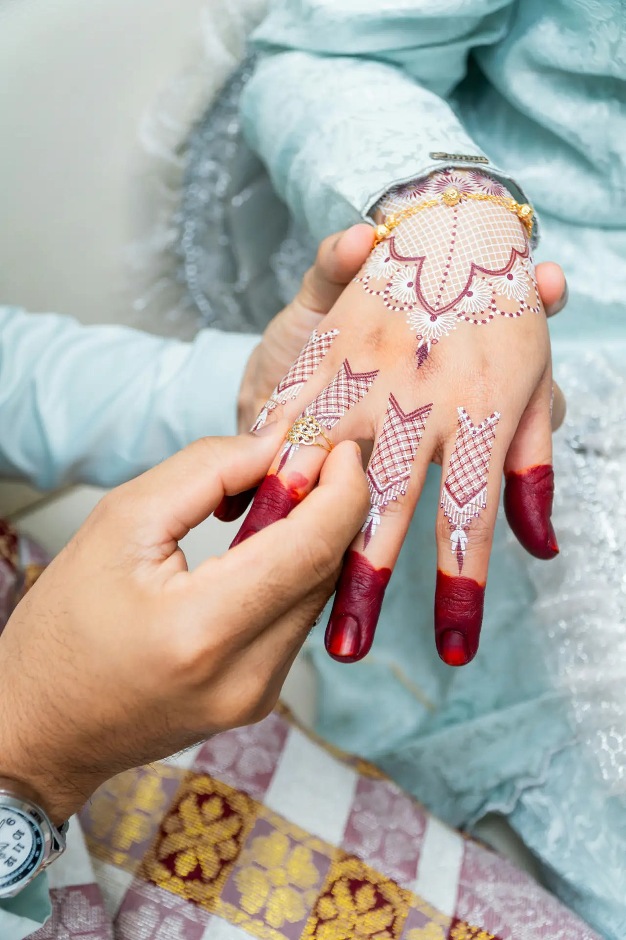 Hennaed hand with a ring