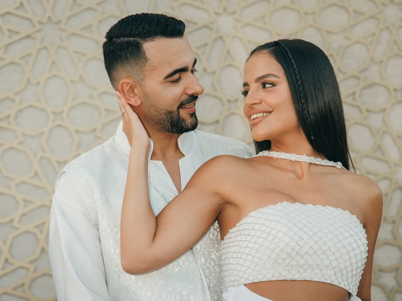 Couple close together in white