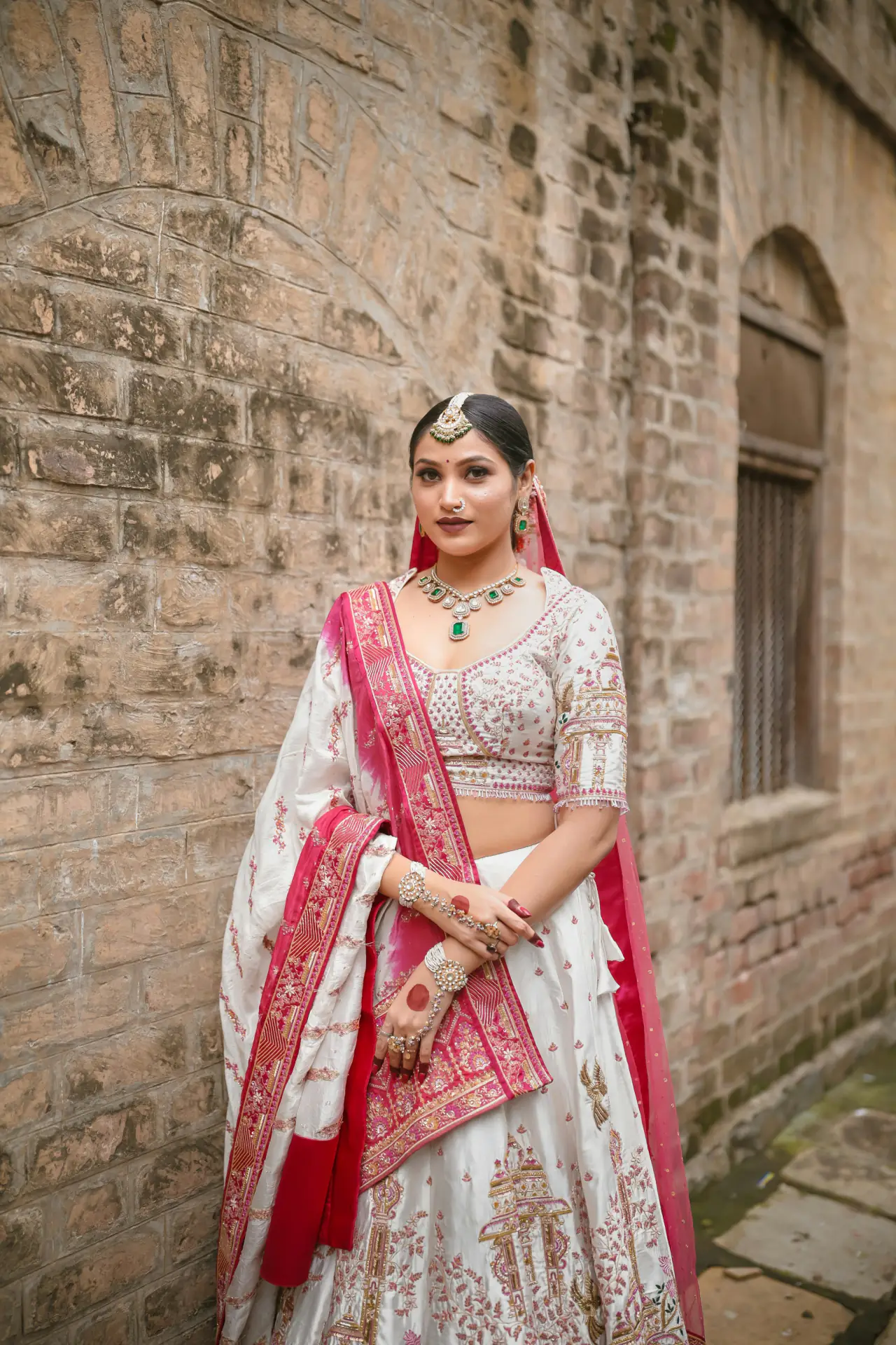 Bride in an ivory and rose lehenga