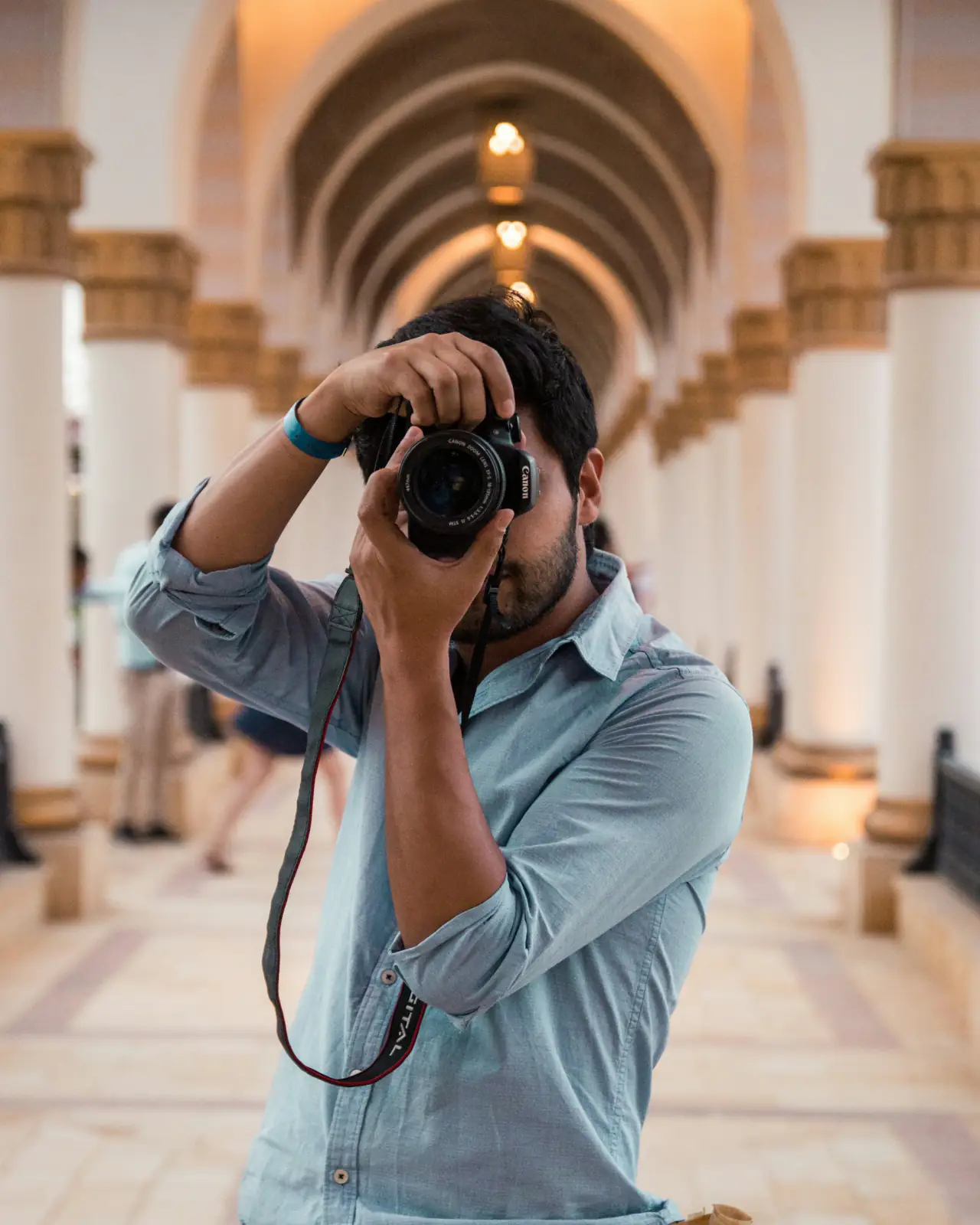 Photographer shooting under stone arches
